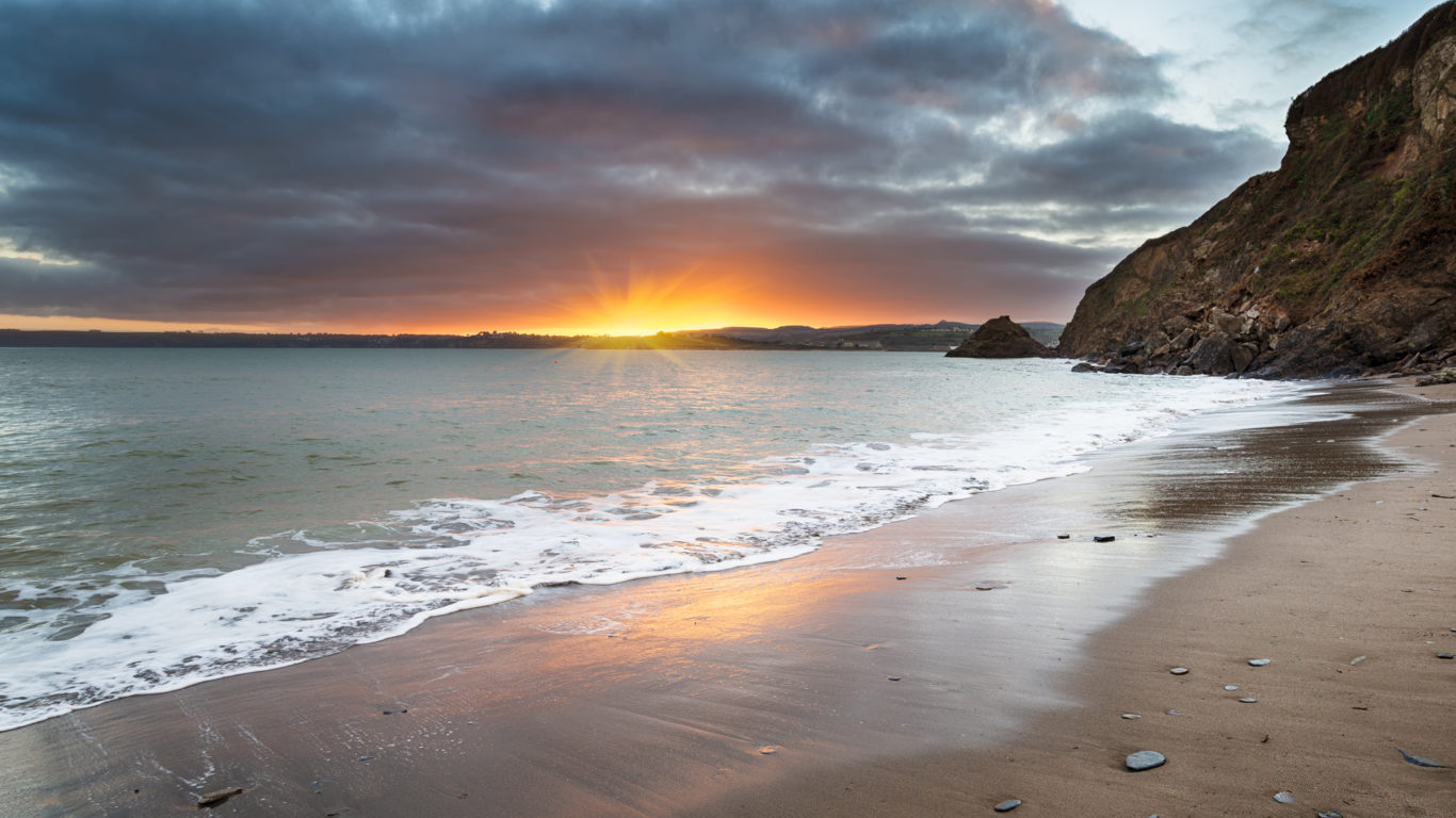 Sunset at Polkerris Beach near St Austel on the south coast of Cornwall