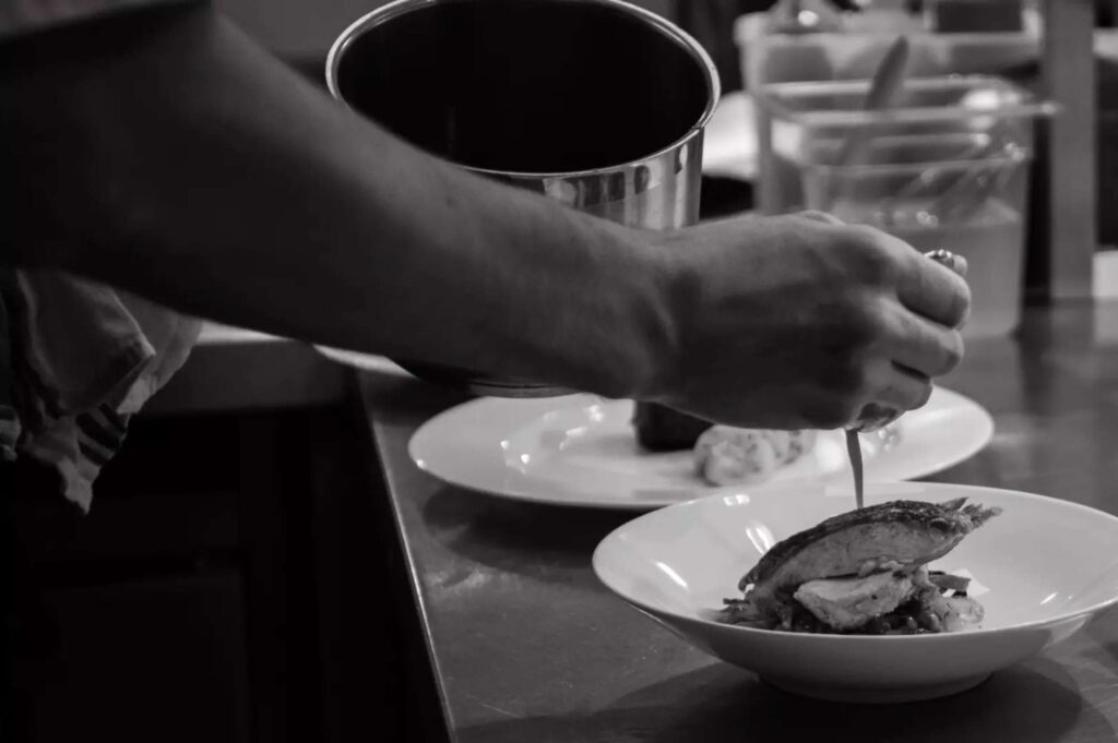 chef pouring sauce